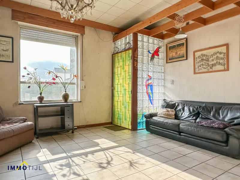 Halfopen woning met 4 slpks, tuin en garage te Denderleeuw!